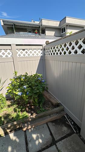 Custom white lattice and gray solid vinyl fence for a homeowner. Custom white lattice and gray solid vinyl fence for a homeowner.