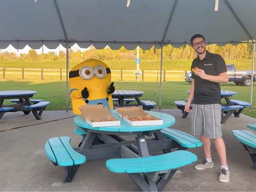 Our Minion Mascot tryin' to steal a slice of pizza from Cole Metherall!