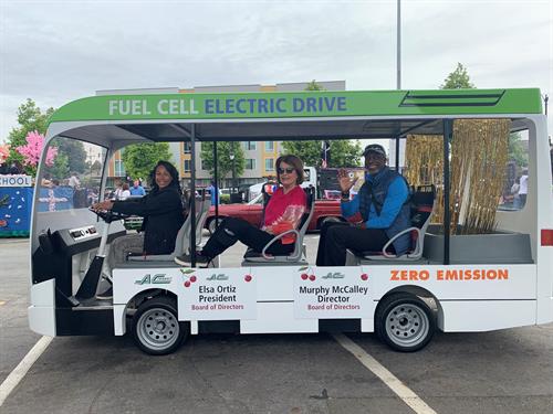 AC Transit Board Directors Elsa Ortiz and Murphy McCalley celebrate the City of San Leandro's 150th Birthday aboard a mini-fuel cell battery bus in the community parade.