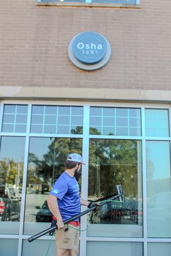 Our technician cleaning Osha's exterior windows using our pure water technology. We utilize our pure water technology on the exterior glass whenever applicable for the longest lasting clean! 