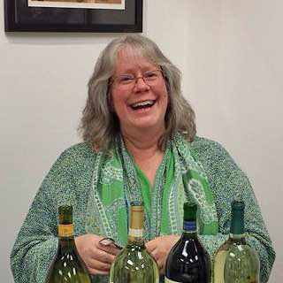 Judith HeartSong pours wine