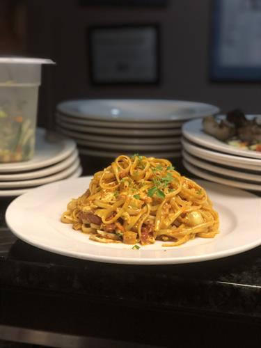 Our "Dads Pasta" is rich with a tomato cream sauce accented with just a touch of curry