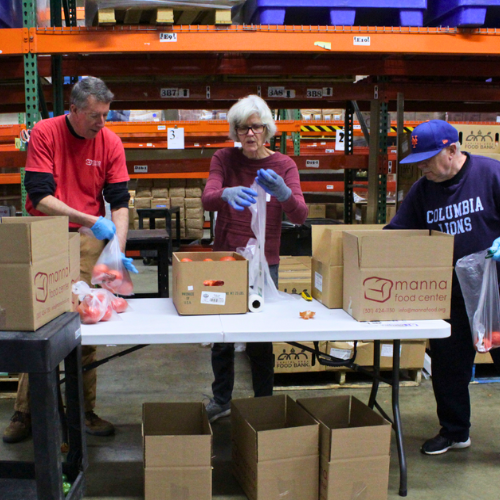 Manna volunteers packing boxes in the warehouse. Manna volunteers packing boxes in the warehouse.