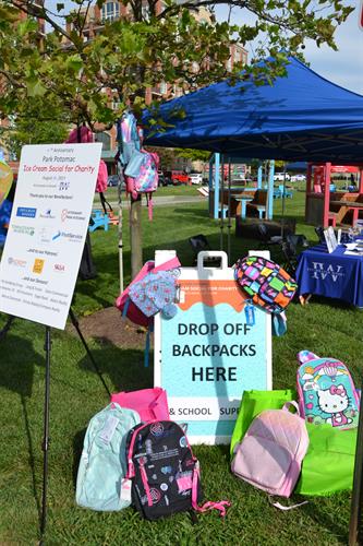 Backpacks and drop off sign infront of IW tables