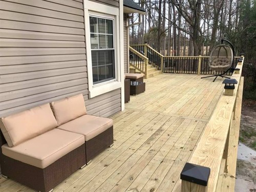 This is a very large deck we constructed for this customer. They chose to use pressure treated decking and black spindled railing to complete the look they wanted.