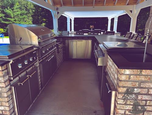 a custom outdoor kitchen and fireplace built by Carmel Landscapes in Russel Township Ohio