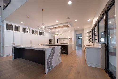 Kitchen of Contemporary Haven Custom Home by Otero Signature Homes 2023