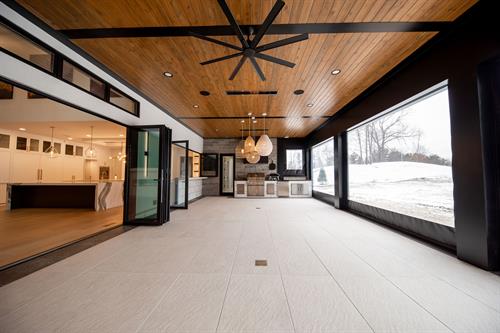 Enclosed Patio with Retractable Vinyl Screens of Contemporary Haven Custom Home by Otero Signature Homes 2023