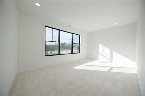 Upstairs Guest Bedroom of Modern Minimalist Custom Home by Otero Signature Homes 2024