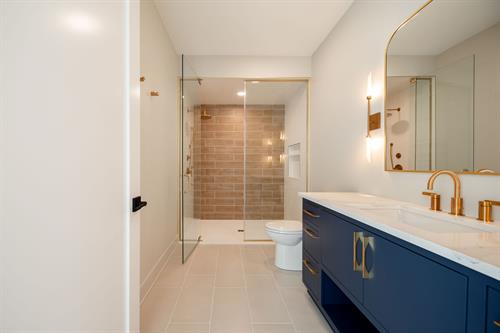 Upstairs Guest Bathroom of Modern Minimalist Custom Home by Otero Signature Homes 2024