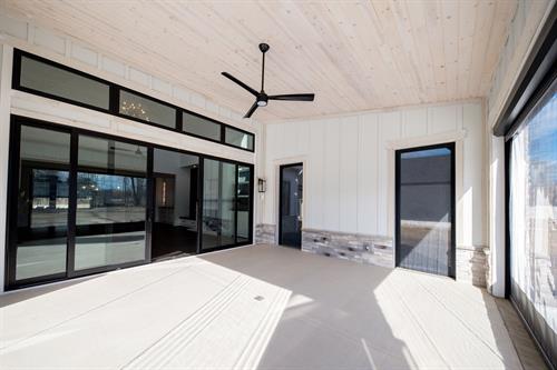 Patio with Retractable Vinyl Screens of Modern Minimalist Custom Home by Otero Signature Homes 2024