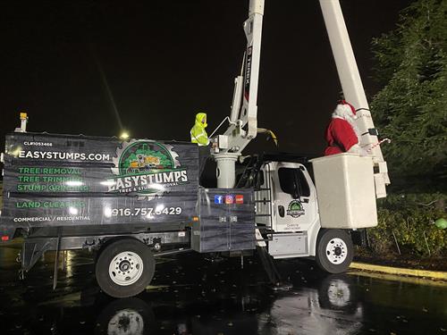Helping Santa light the tree Helping Santa light the tree
