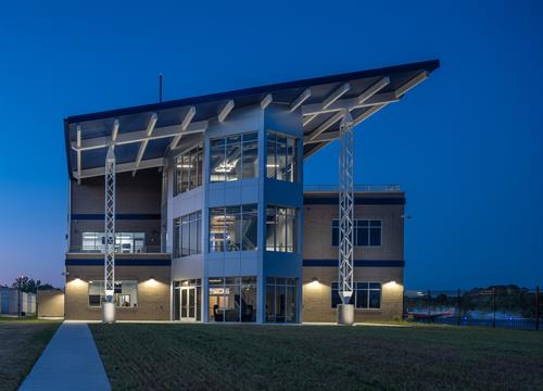 Blue Line Aviation headquarters at Johnston County Regional Airport lit up a twilight.  