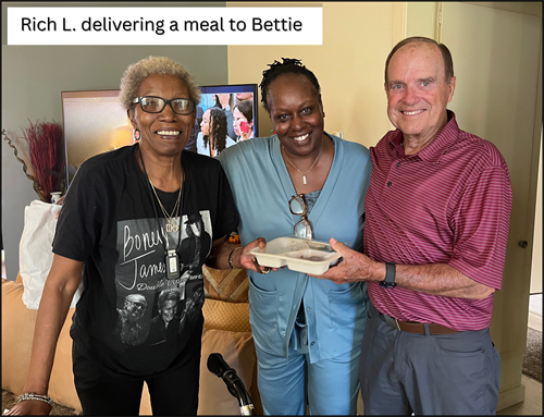 A client and her caregiver receiving a daily meal delivery
