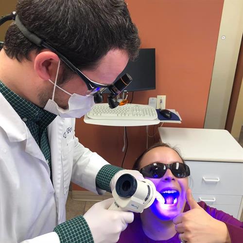 Dr Fenn giving a VELscope Oral Cancer Screening