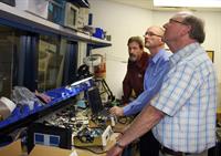 Byron Johnson (LBA), Josh McIntyre (Trewmac), and Marcian Bouchard (LBA) look at calibration features of the new TE-3000 impedance analyser in the LBA lab.