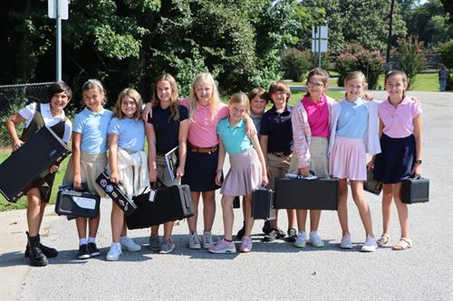 Fifth grade students smile for the camera as they return from band class.  