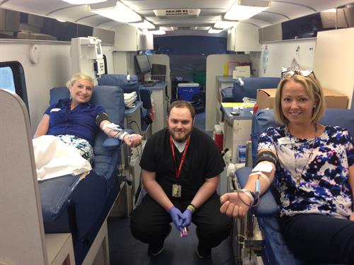 Executive Director and Director of Sales giving Blood together