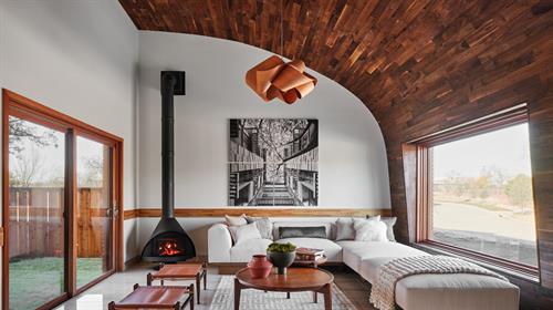 Formal living room with curved wood ceiling…