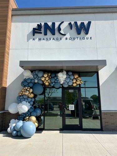 Elegant storefront balloon garland for a business grand opening.