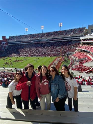 Local coordinator and students at a football game in Arkansas