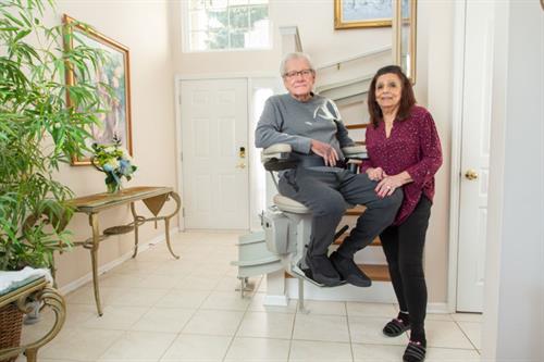 Gallery Image woman_standing_next_to_her_husband_who's_sitting_on_a_stair_lift.JPG