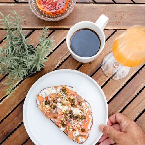 Lox on toast, locally roasted coffee, and mimosa with fresh-squeezed orange juice
