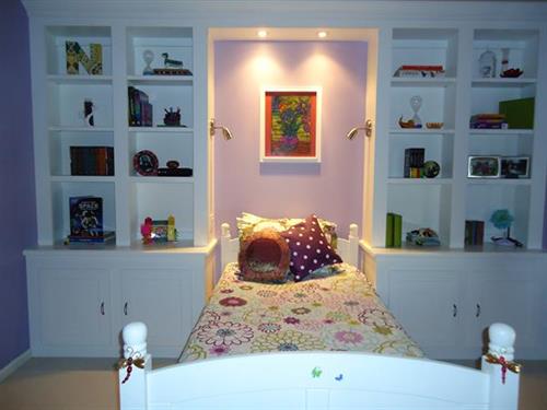 Girl's Bedroom with custom cabinetry, lighting highlights her own artwork!
