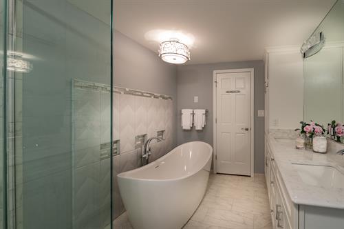 Stunning Master Bathroom! Step into this glamorous modern light and airy space. Oversize shower with hotel style rain-head, freestanding soaker tub, dual sinks, large mirror, multiple shower functions, porcelain tile-marble look, storage, and more.