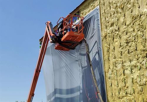 Applying Closed-Cell Spray Foam on Building Exterior