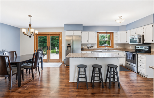 Open kitchen and dining space at 67 W Wood Ridge Dr in River Falls