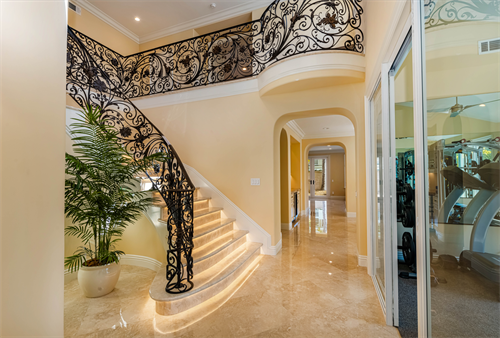 Custom iron railing and lighting under steps 