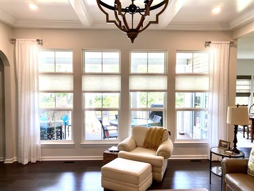 Sheer drapery side panels with cellular shades.