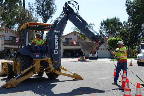  Utility crew performs a service replacement in a residential area of El Cajon.