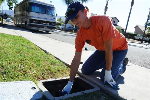 Meter maintenance staff member performs general maintenance to a customer’s water meter.