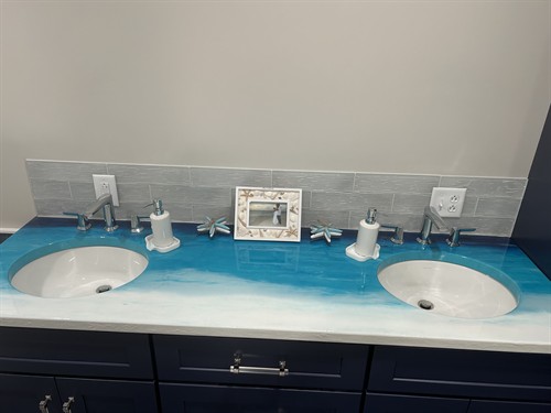 “A countertop that clocks out and goes on vacation—every single day.” If you want a softer, more poetic vibe, another option: ?? “Where the morning routine meets the shoreline—bringing vacation energy home.” Or a slightly playful one: ? “Because brushing your teeth should feel like stepping onto the beach.” If you want, I can tailor it to the exact colors, textures, or mood of the piece.