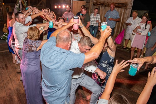 A party dance tunnel makes way for the bride and groom in a SE Wisconsin barn wedding. Steve Sweeney Photography