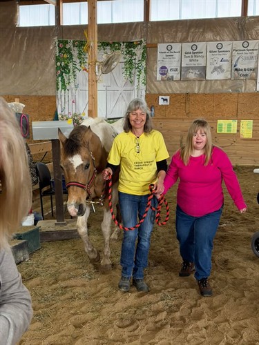 Learning to lead and walk a horse during a group event!