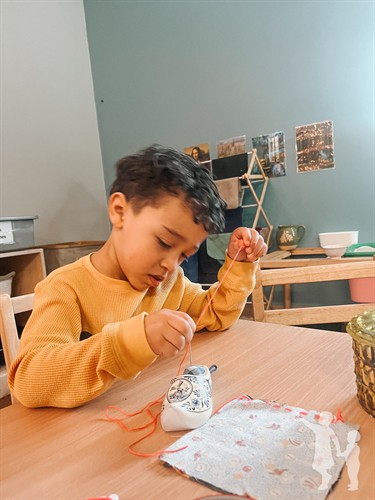 Fascinated by sewing while working on hand-eye coordination and concentration