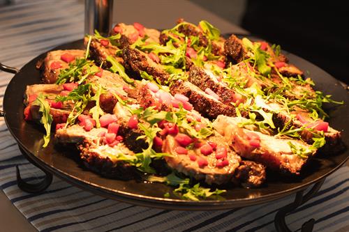 Strip Loin Marinated with Olive Oil, Rosemary, Oregano, Garlic, and Lemon. Topped with Arugula and Red Pepper Salad with a Lemon Vinaigrette