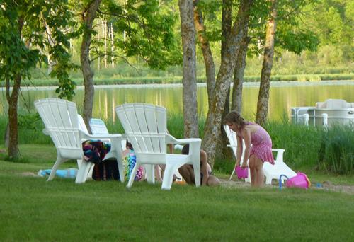 Playing on resort grounds close to the beach, quiet evening on the lake. 