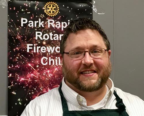 Scott Hewitt served Fireworks Chili at the Cook-off for the Food Shelf in 2019