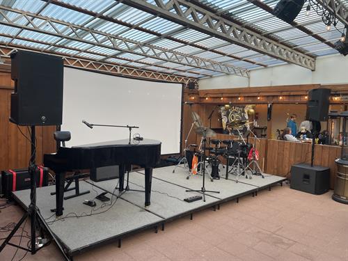 Stage setup for Reggie England: A Tribute to Elton John at the Back Alley North Bend
