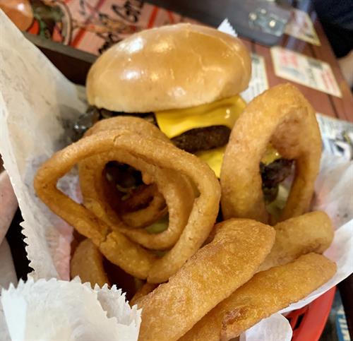 Charburger with cheese and onion rings
