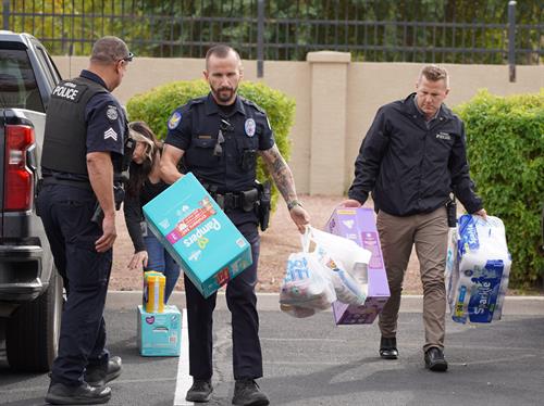 Peoria Officers delivering food and diapers to a family in need