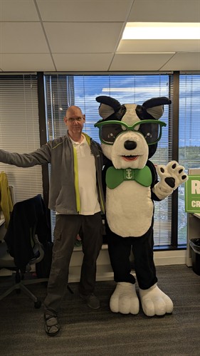 Tim with Maxx the mascot of Cruise Planners Home Office