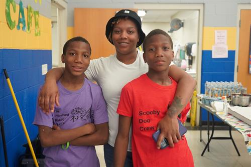 Robotics Team Members and their mom smile at the 2022 Spring Robotics Showcase during Remake Learning Days