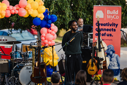 An emerging artist presents at a Build WyCo community event.