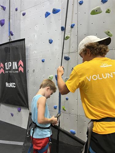 HopeKid with Volunteer climbing during Rock Climbing Event 