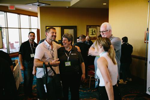 Gear Performance Group Members laugh with vendors and Institute staff at The Institute's Summit 2023